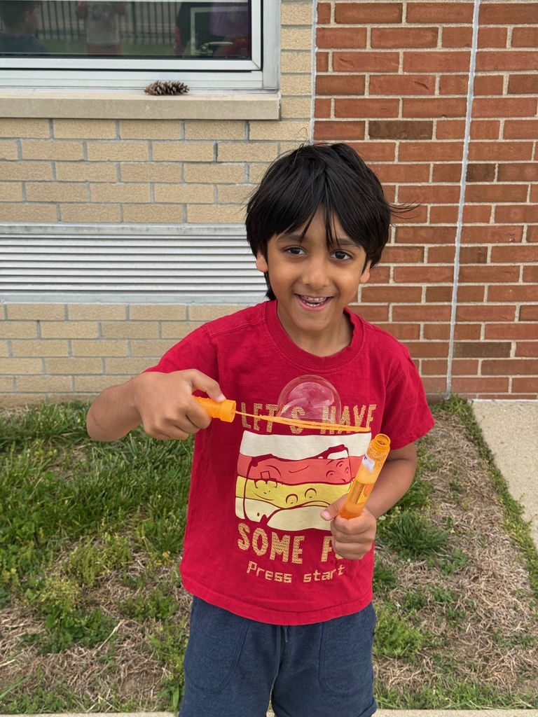 student blowing bubbles on B for Bubbles day