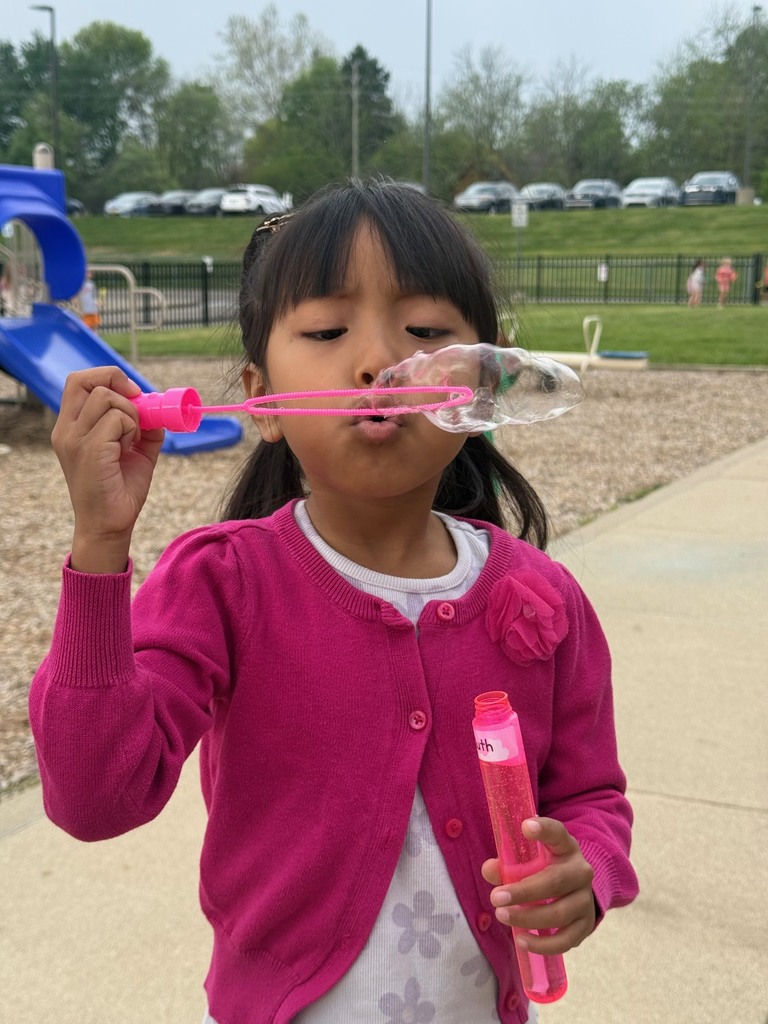 student blowing bubbles on B for Bubbles day