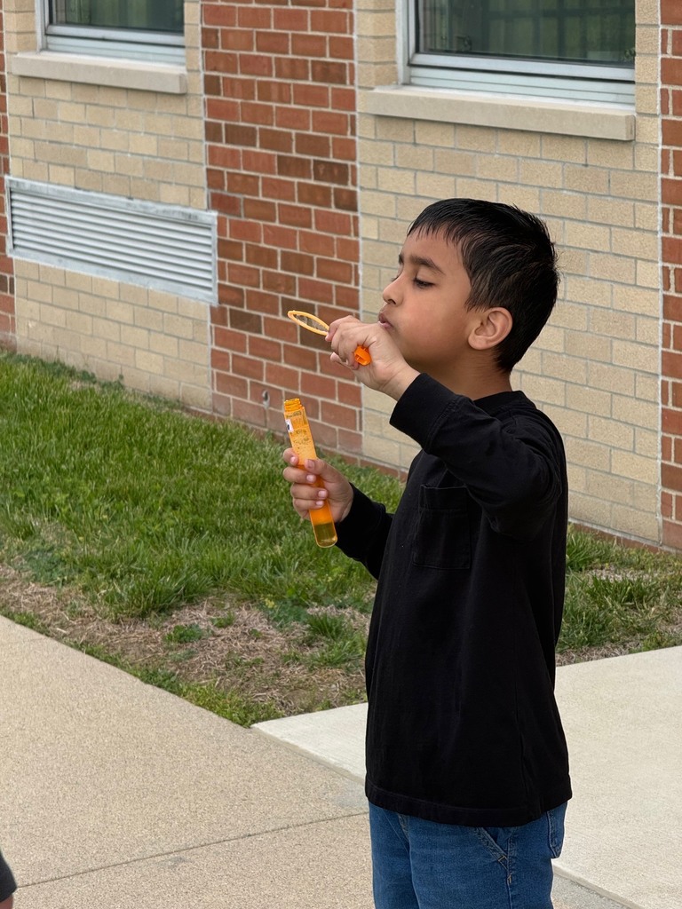 student blowing bubbles on B for Bubbles day