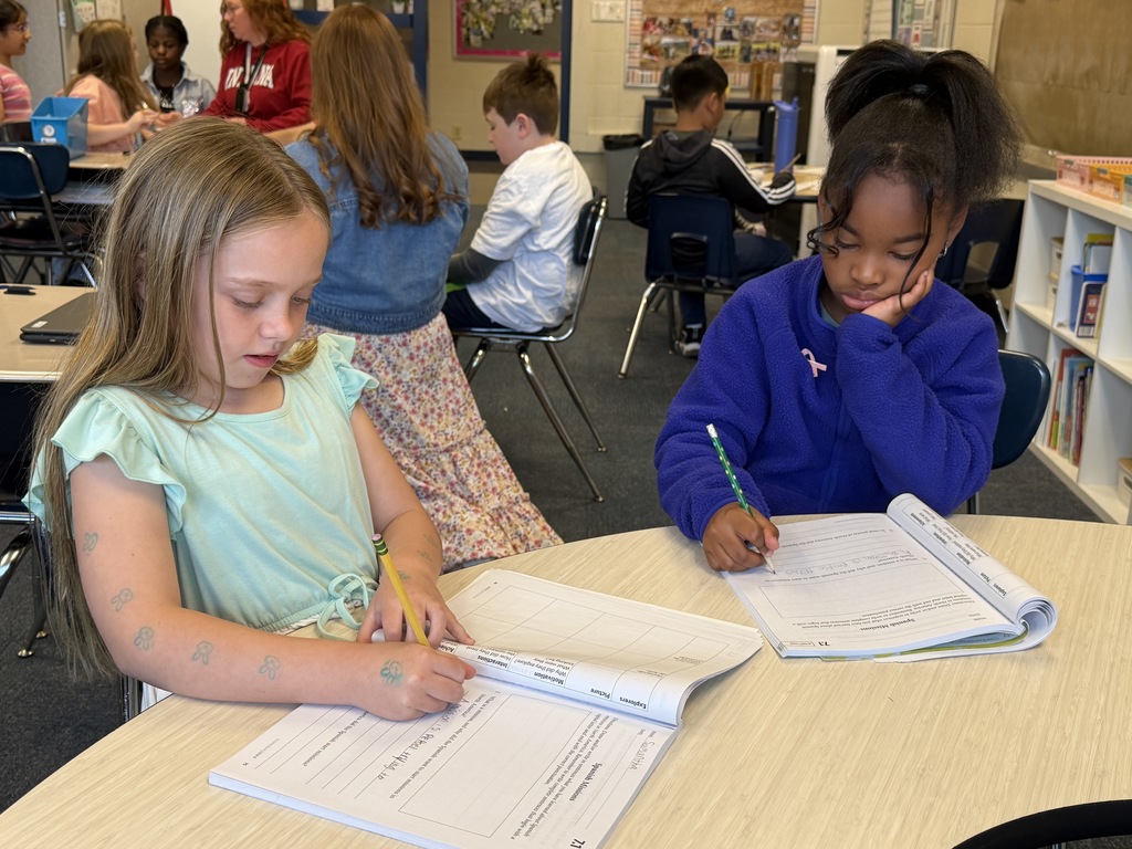 two students working together on workbooks
