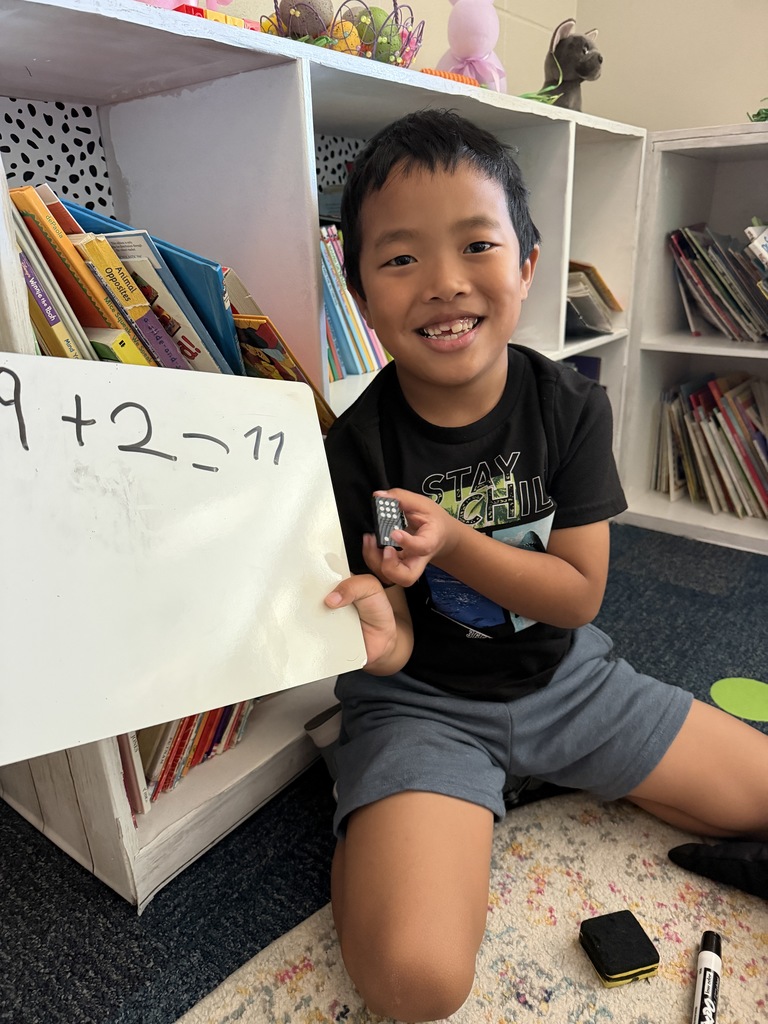 student doing math on dry erase board