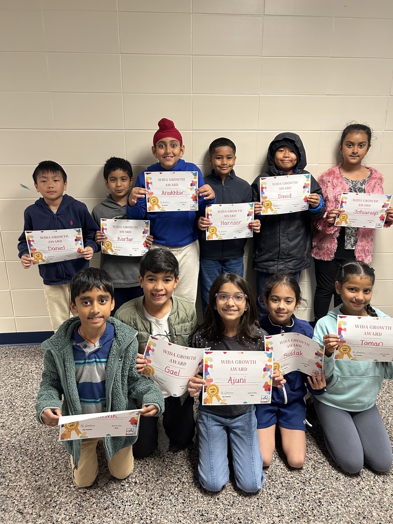 students holding certificates for improved WIDA scores