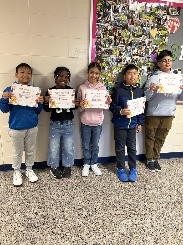 students holding certificates for improved WIDA scores