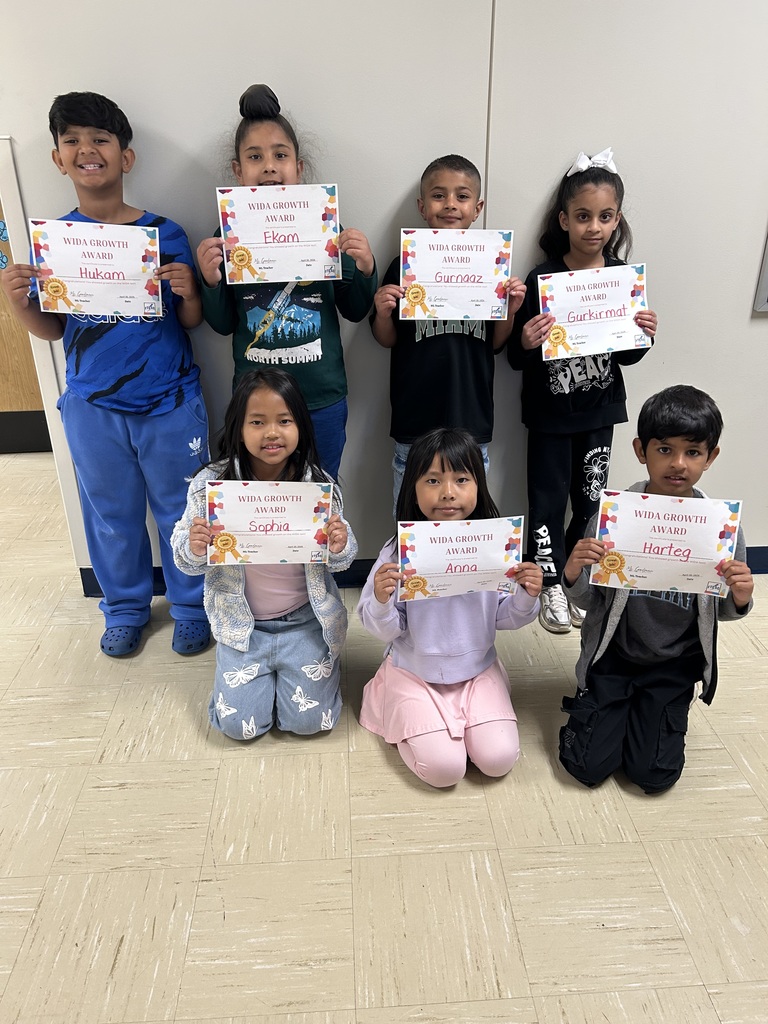students holding certificates for improved WIDA scores