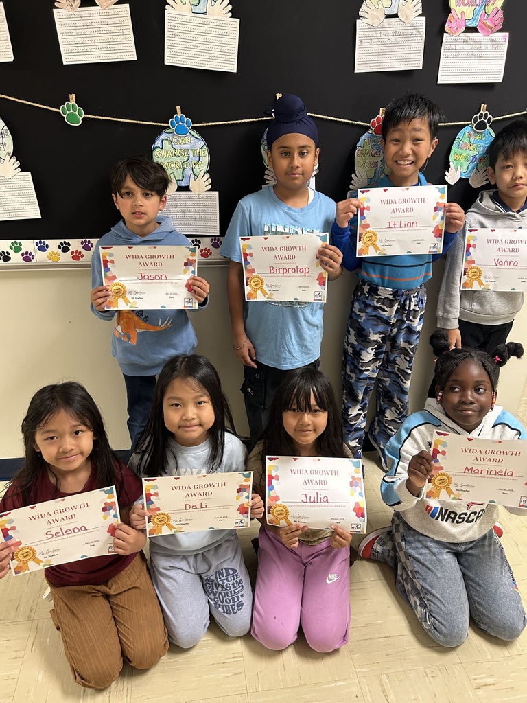 students holding certificates for improved WIDA scores