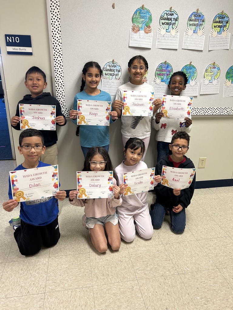 students holding certificates for improved WIDA scores