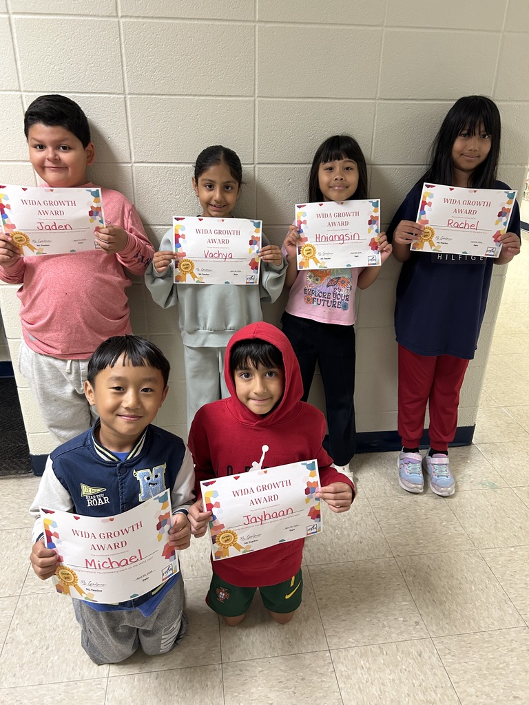 students holding certificates for improved WIDA scores