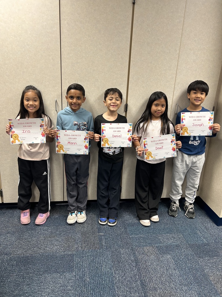students holding certificates for improved WIDA scores
