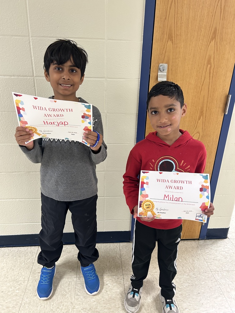 students holding certificates for improved WIDA scores