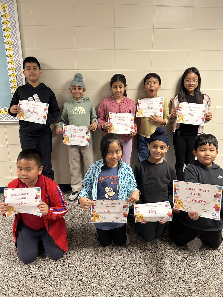 students holding certificates for improved WIDA scores