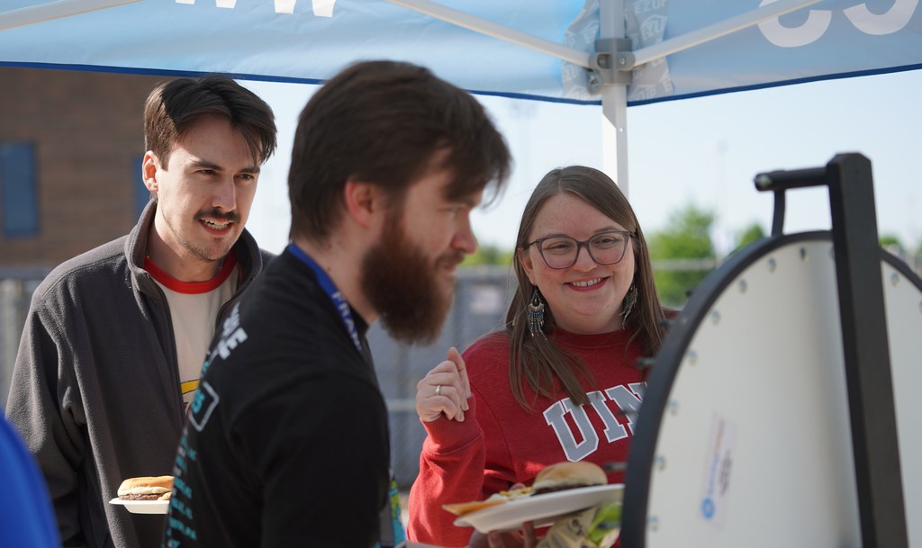 Staff spinning the wheel at the FC cookout