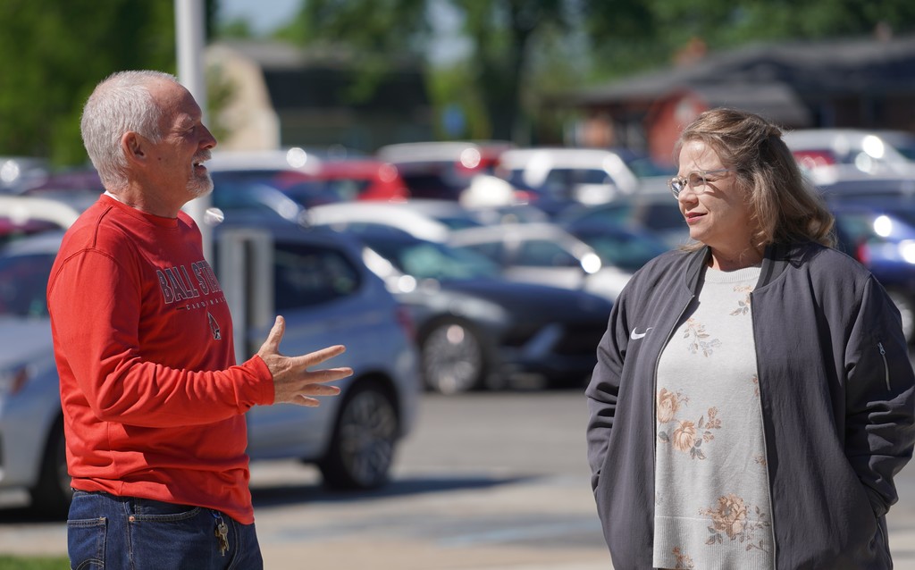 Two people interacting outside