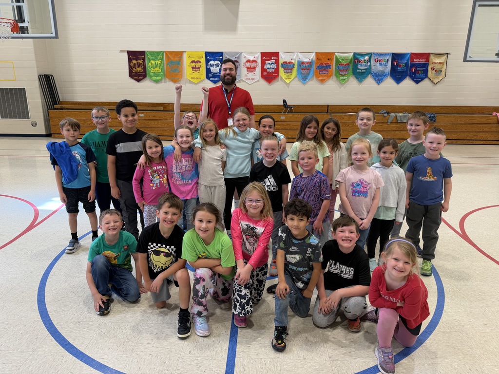 Mr. Ratliff (gym teacher) with students in the gym celebrating completing Finn's Mission