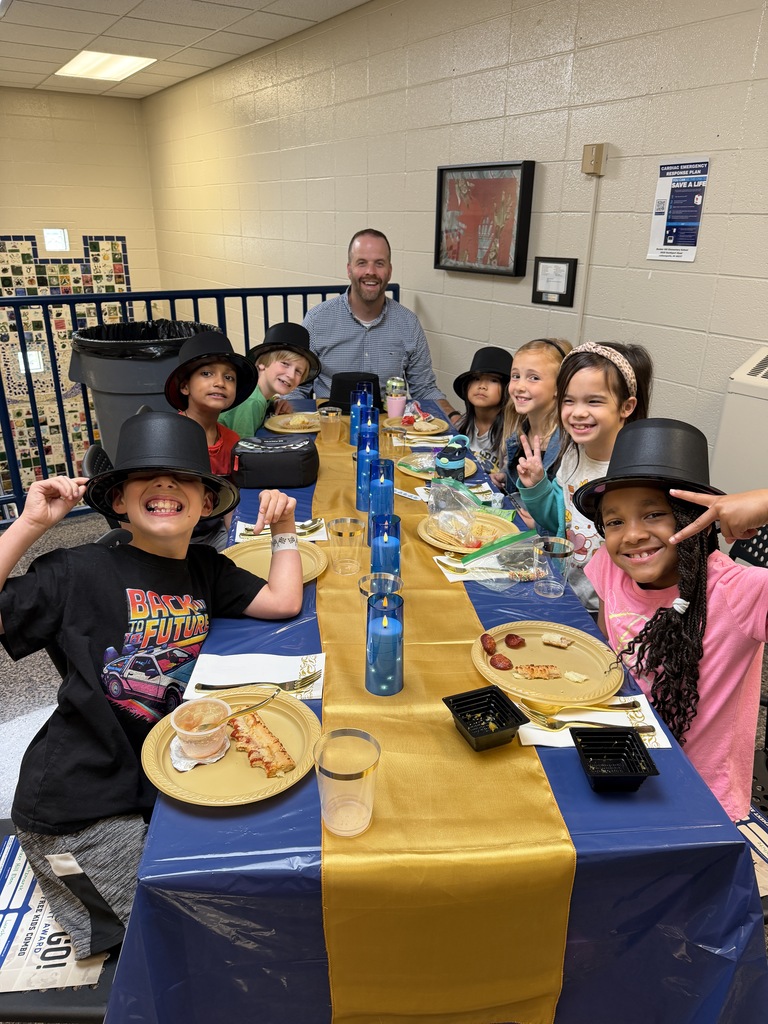 Lunch at the Ritz - students smiling with an administrator