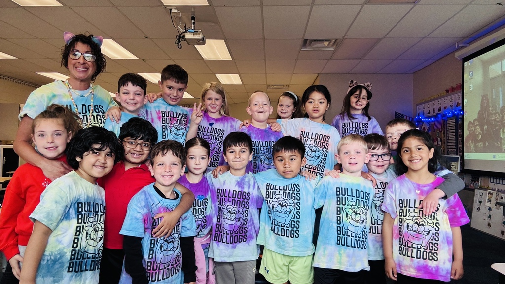 Mrs. Gorske's kindergarten class smiling together in tye dye shirts for T day