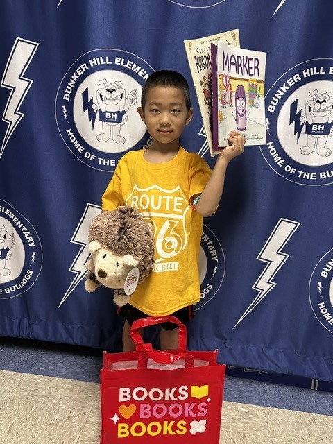 Book raffle winner smiling with their prize