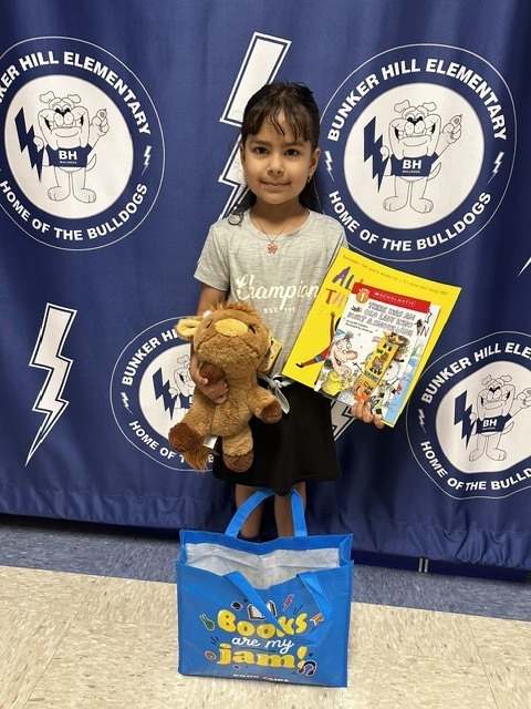 Book raffle winner smiling with their prize