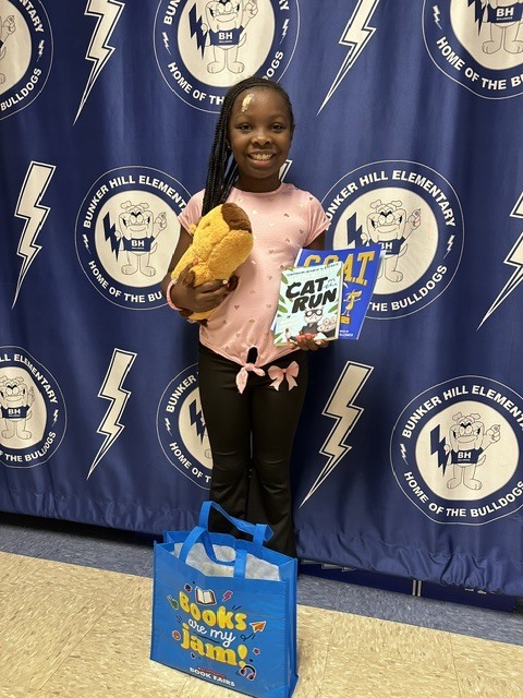 Book raffle winner smiling with their prize
