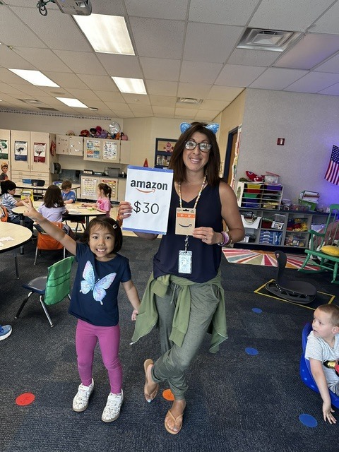 Book raffle winner smiling with their prize