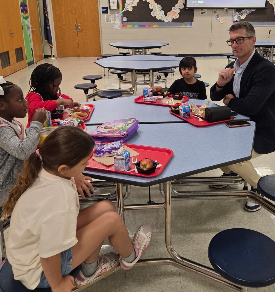 Dr. Huotari eating lunch with second grade students.