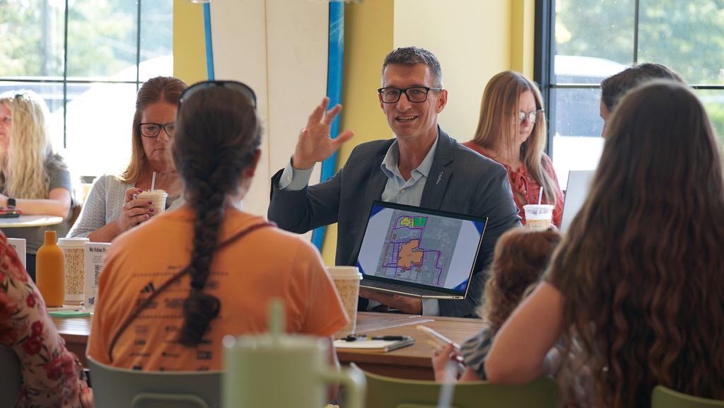 Dr. Huotari talking with community members about school