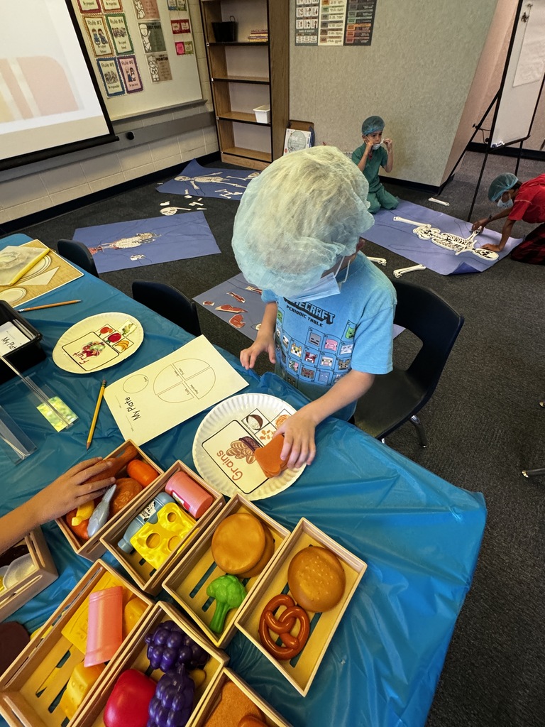 first grade OR day where students are wearing scrubs and doing body themed activities