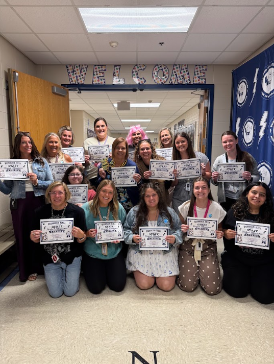 group photo of staff members with perfect attendance holding certificates with