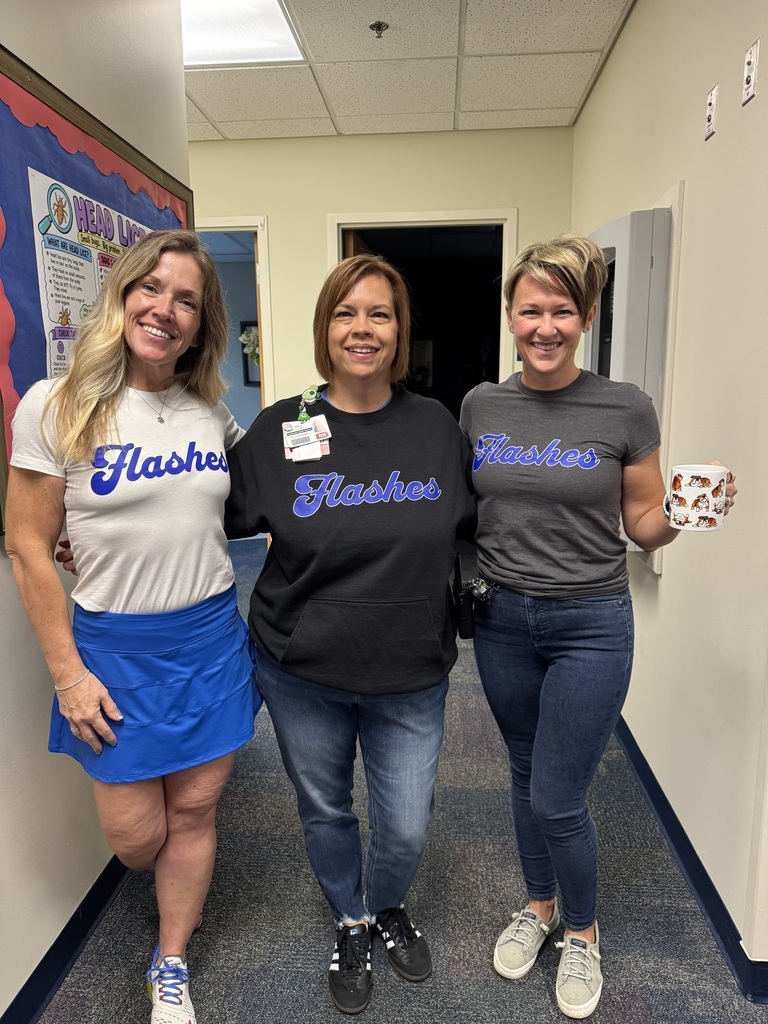 three adults smiling together as they wear shirts with FLASHES in the same font