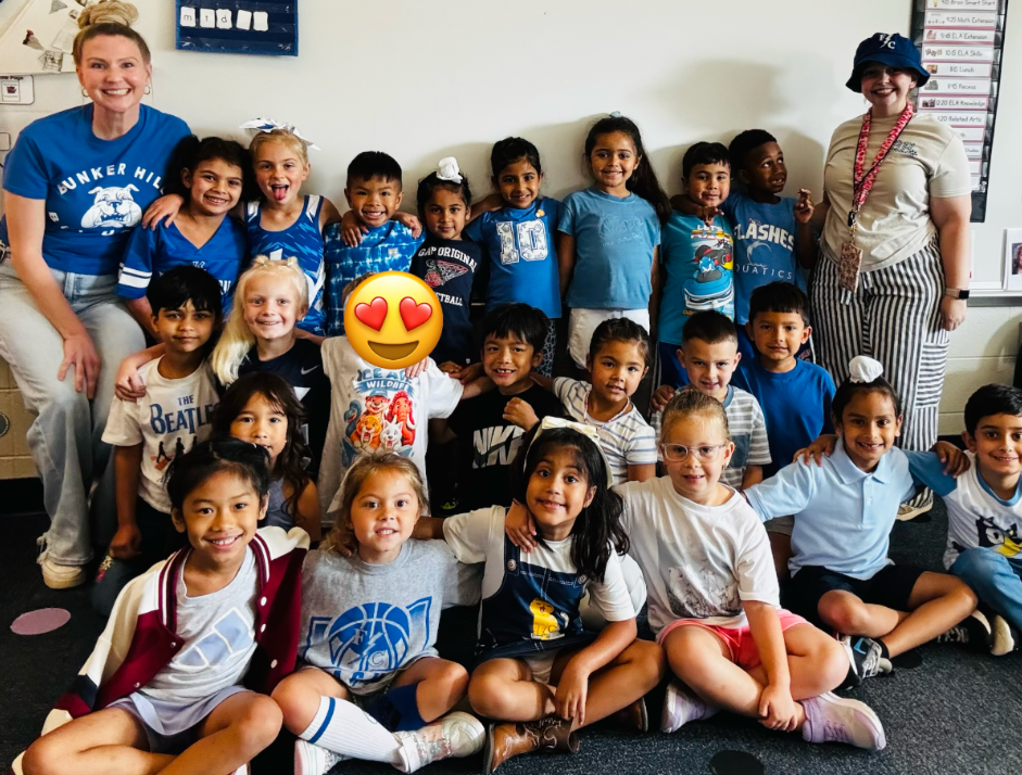 Miss Milligan's kidnergarten class smiling together wearing blue for spirit day