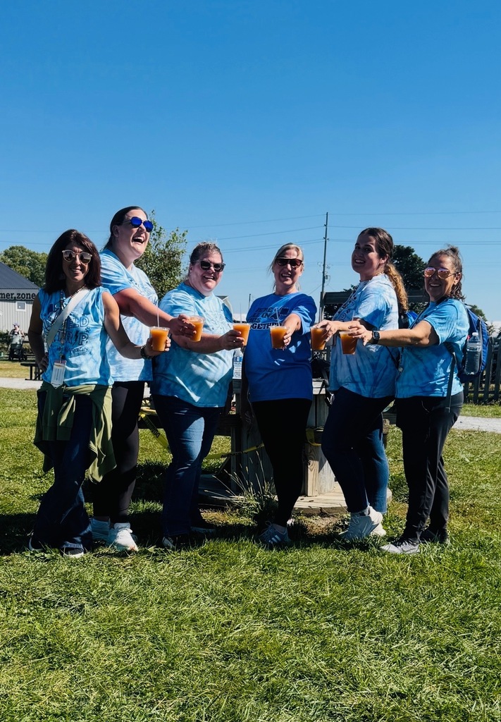 Bunker Hill staff smiling together holding their cups of apple cider