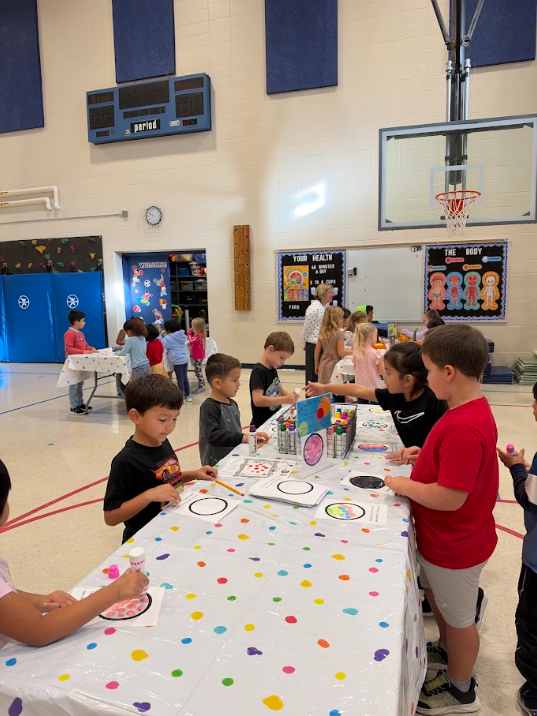 Kindergarten participating in activities in the gym during UNITE day