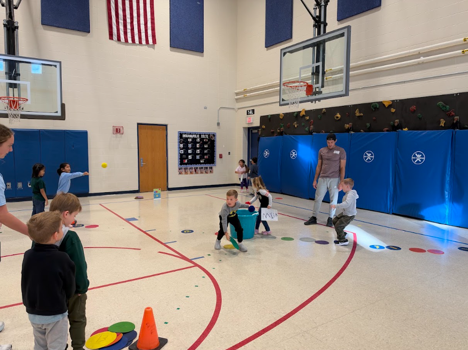 Kindergarten participating in activities in the gym during UNITE day