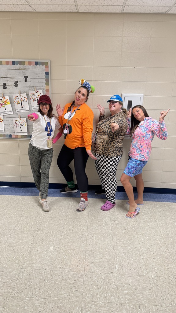4 teachers doing silly poses together in mismatched clothing
