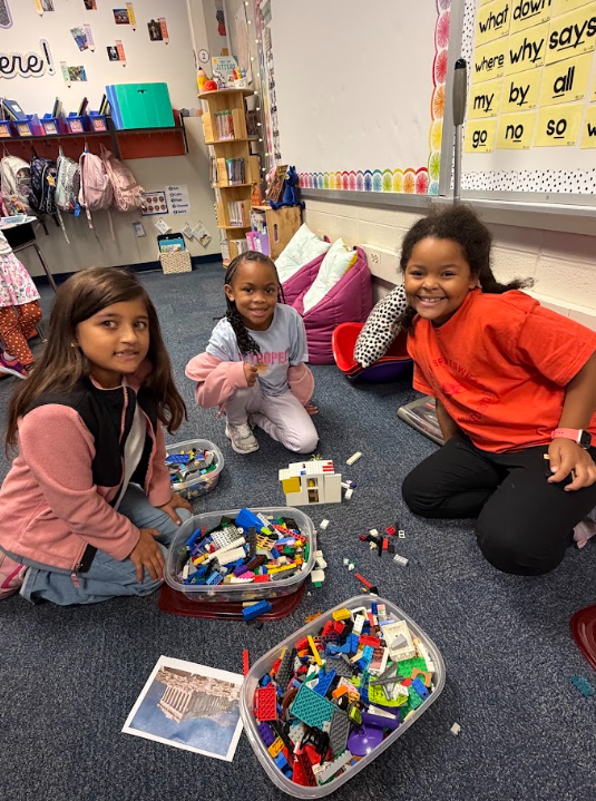 students building Grecian style buildings out of legos on the floor