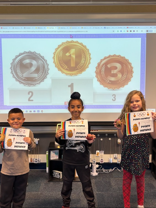 students smiling with their certificates for potato distance