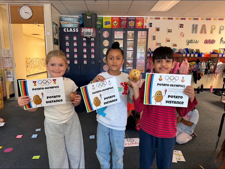 students holding up certificates and their decorated potato 