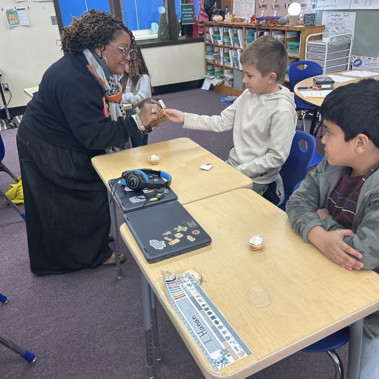 teacher giving students ingredients for pie