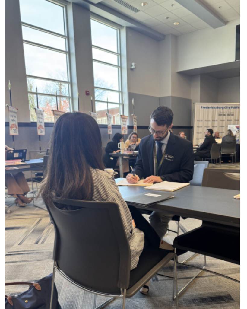 Assistant Principal interviews applicant.