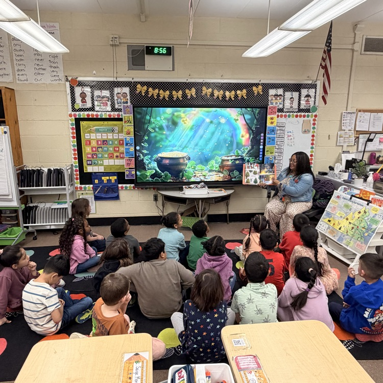 Mrs. Lewis reads to the kids. 