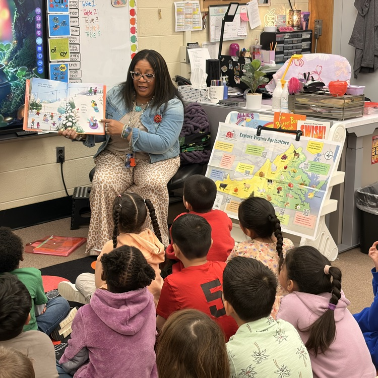 Mrs. Lewis reads to the kids. 