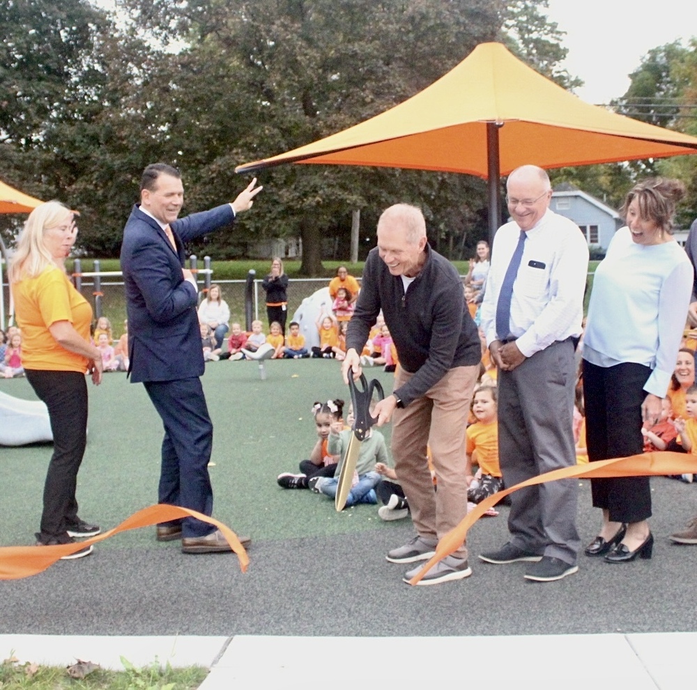 BOE President Steve Johnston cuts the ribbon while Amy Piper, Wheelock Principal, DR Z, Superintendent, John Forbes, Business Administrator, and Dr. Margie Wright, Chief Officer for Curriculum & Human Resources cheers him on.