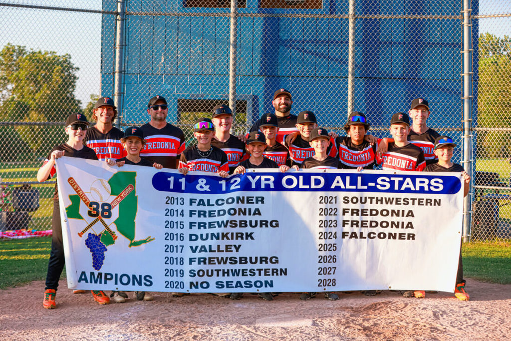 The Fredonia 10-12 All-Stars hold the District 38 championship banner after holding off Southwestern 10-9 on Wednesday at Carroll Town Park. OBSERVER Photo by Ashleigh Brown