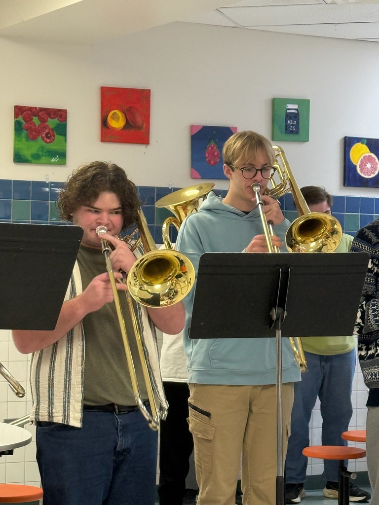 Student musicians performing for staff.
