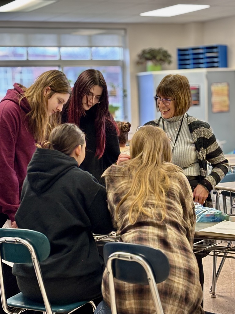 Presenter talking with students at career day.