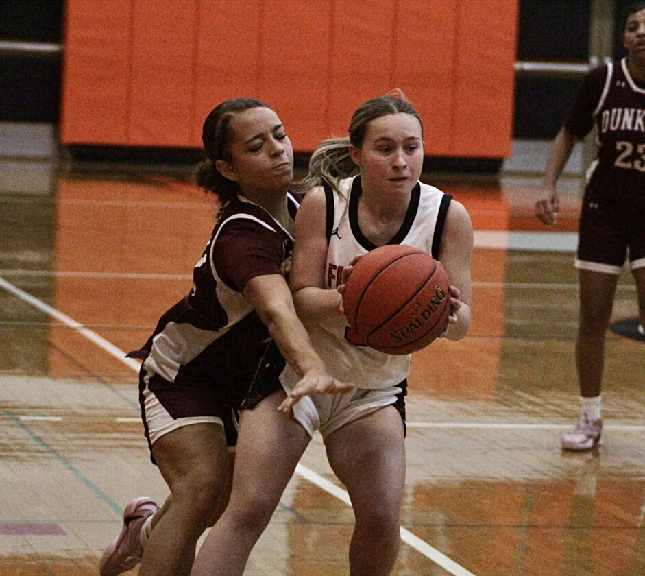 Dunkirk’s Chianti Lopez, left, and Fredonia’s Sophia Burrows, right, battle for the ball during the second half of Tuesday’s CCAA Division 1 girls basketball game at Fredonia High School. OBSERVER Photo by Braden Carmen