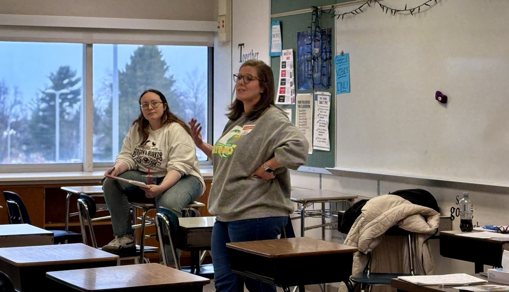 Presenter talking with students at career day.