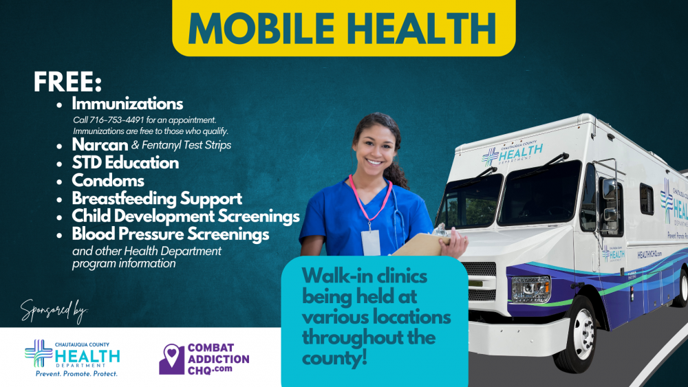 Healthcare working standing in front of a mobile health clinic.