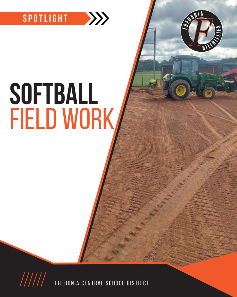 Tractor with attachments working on improvements to the softball field.