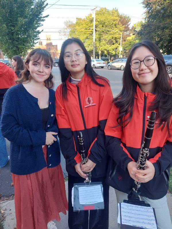Band members pose with a friend before the parade.