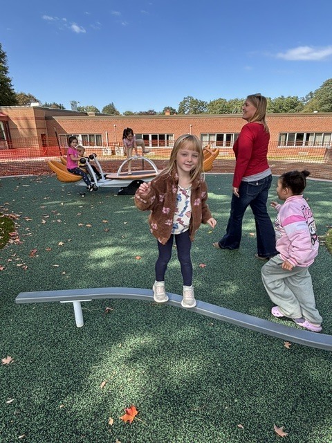 Wheelock students play on various pieces of equipment on the new Main St. playground.
